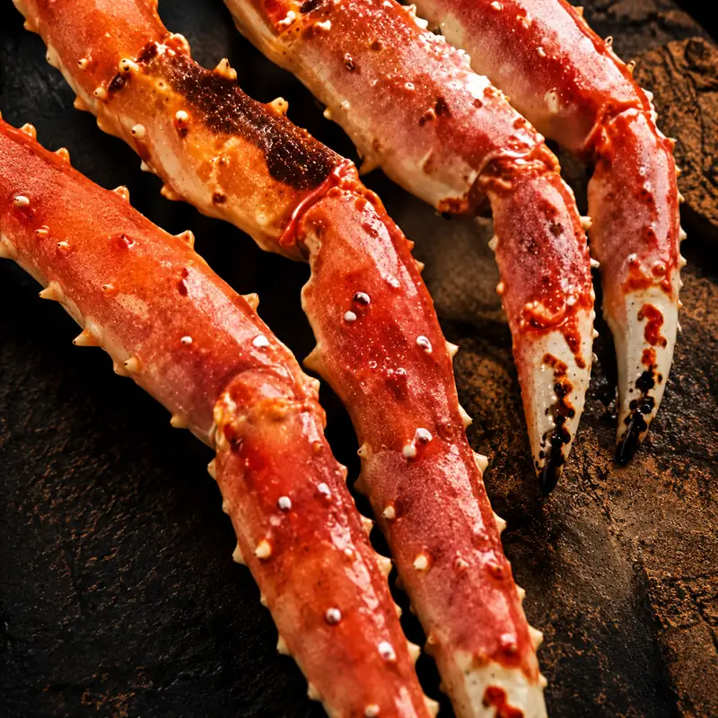 Close-up of premium Norwegian king crab legs, highlighting their distinctive red shell and tender seafood meat.